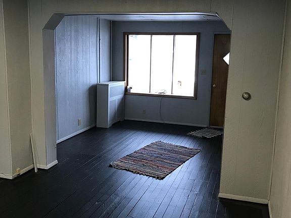 View from kitchen (through dining area) to living room (front door).