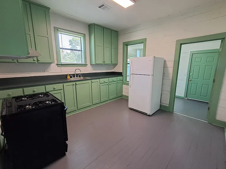 Kitchen with refrigerator, stove, range hood, lots of cabinet space