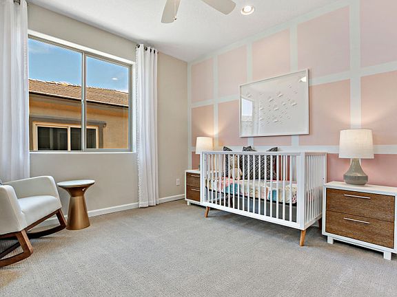 Bedroom 3 features a large window, pink accent wall, and overhead lighting perfect for a children s