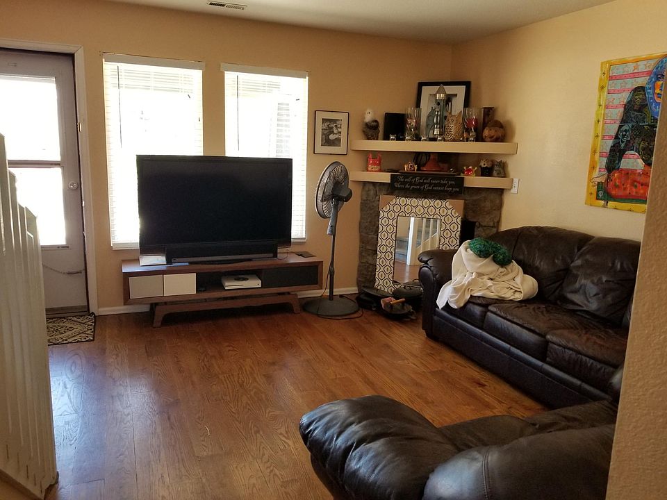 The living room has hardwood floors and a gas fireplace.