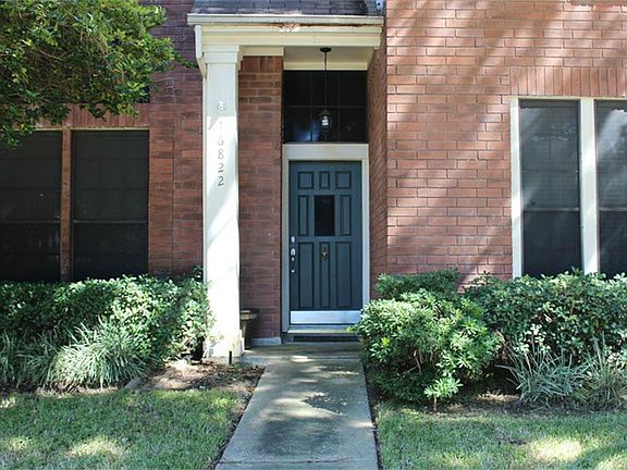 Front door entry and windows with solar screens.