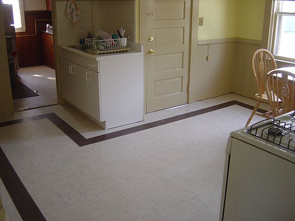 The second floor kitchen and pantry with door to hallway and stairs