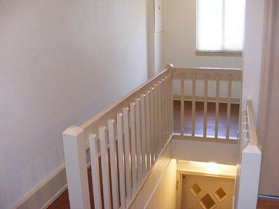 Visible in this picture is the front door at the bottom of the steps. The area near the window is the office nook.
