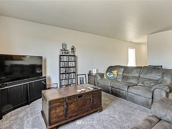 View of family room, entrance is straight ahead, kitchen off to right.