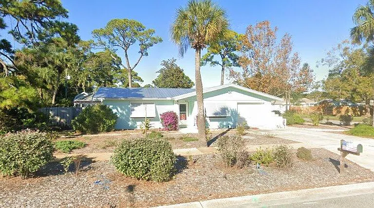 Street view of this Florida home. Beautiful Bahama shutters installed in 2023 are rated for hurricane protection and very easy to lower. Other windows have accordian shutters.
Metal roof was installed June 2023.
AC Unit replaced in June of 2026.