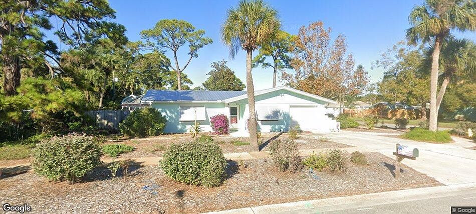 Street view of this Florida home. Beautiful Bahama shutters installed in 2023 are rated for hurricane protection and very easy to lower. Other windows have accordian shutters.
Metal roof was installed June 2023.
AC Unit replaced in June of 2026.