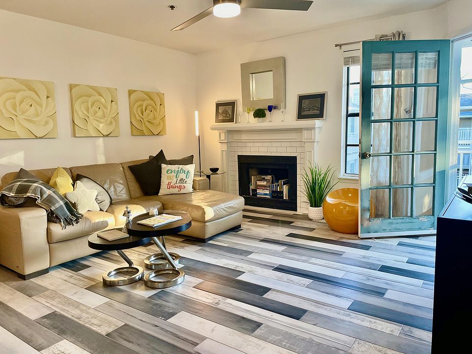 Living room with fireplace and door to patio.