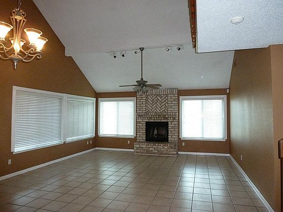 Light and bright living area lots of windows with storm window covers and two inch blinds