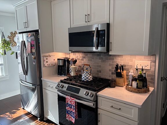 Another view of the kitchen that showcases the current tenants' decor.