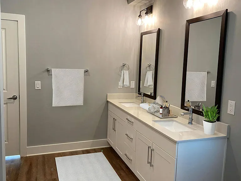 Double Bath Vanities with Undermount Porcelain Sinks and Framed Mirrors