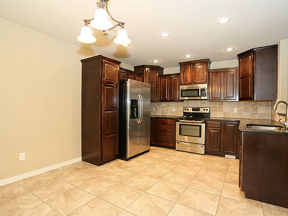 Fully equipped kitchen with stainless appliances and granite