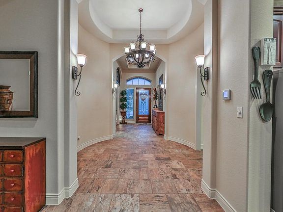 Spacious Rotunda Entry with beautiful tile floor and 13-foot coffered ceilings.