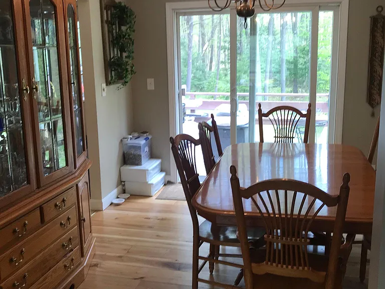 Another dining-room angle showing sliders to deck and backyard.