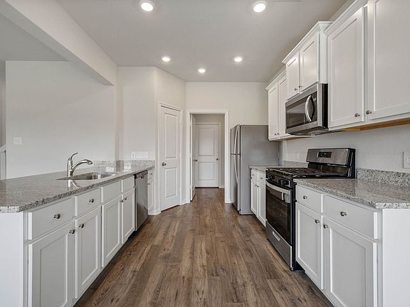 The chef-ready kitchen features granite countertops and stainless-steel appliances.