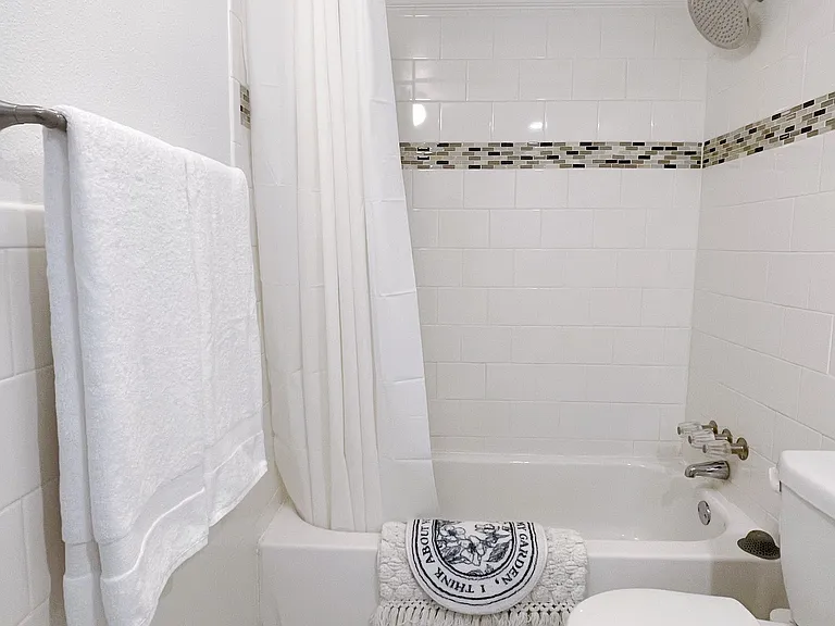 Full bathroom with shower and bathtub.
