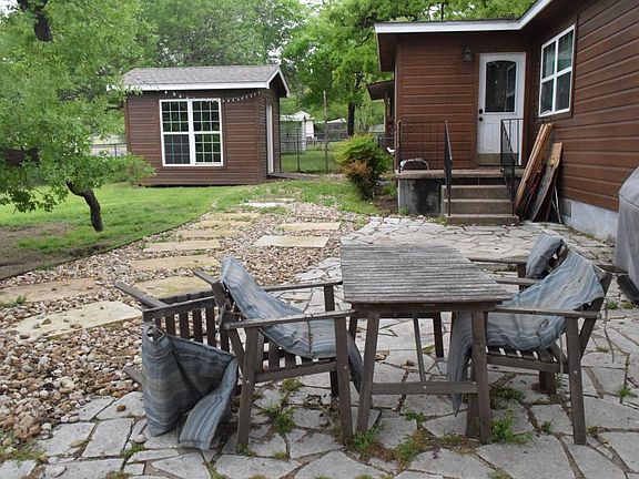 Backyard. Large storage shed. Pavestones.