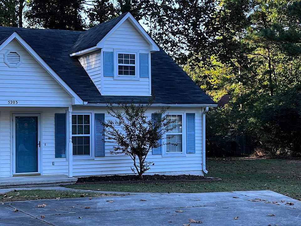 Front of home including dedicated parking.