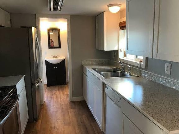 Galley Kitchen with newly updated white cabinetry