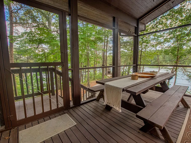 Screened porch overlooking water front.