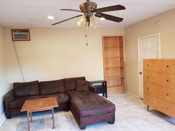 Spacious open living w a ceiling fan and recess lights(couch not included)