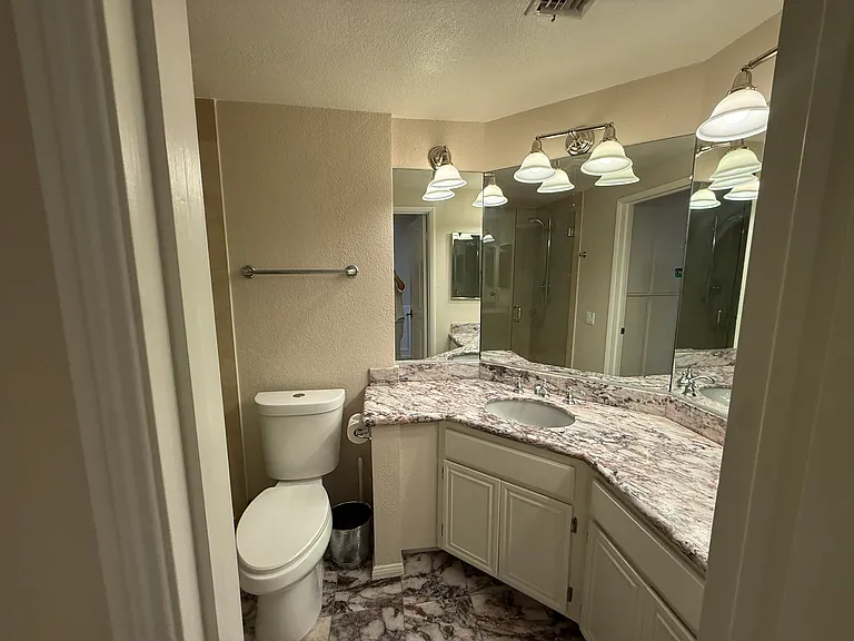 Stone countertops and tiled bathroom floor