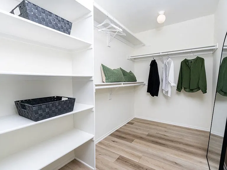 Spacious Closet with Built-In Shelves and Ample Hanging Space