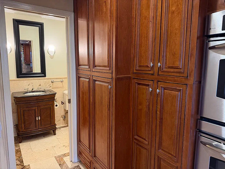 Washer/Dryer in cabinets, pantry and extra storage.