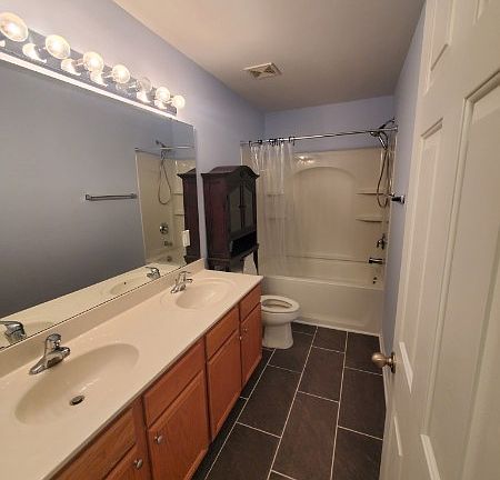 The full bathroom accessible from the bedroom.