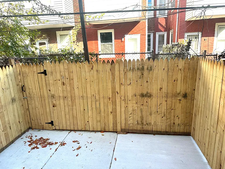 Newly cemented fenced-in backyard.