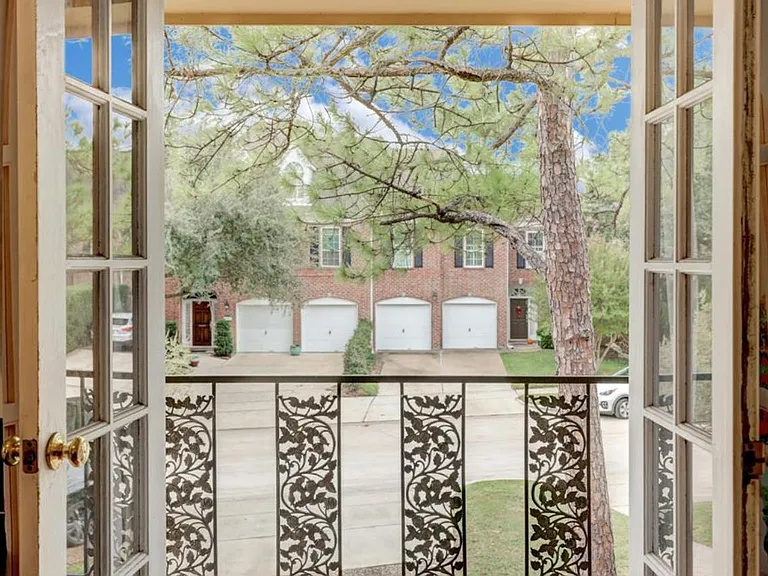 Balcony French door opens to treetop views.