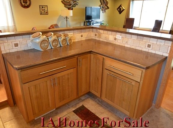 Kitchen: Custom cabinets with lazysusan features in each corner, 2 slide out shelves for pans, and slide out recycling area with 4 separate containers