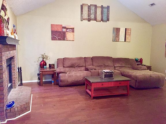 vaulted ceilings, and hardwood floors in living room