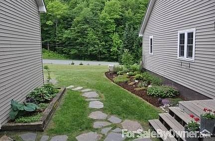 Breezeway
						:
						Stone pathway from driveway and perennial gardens.