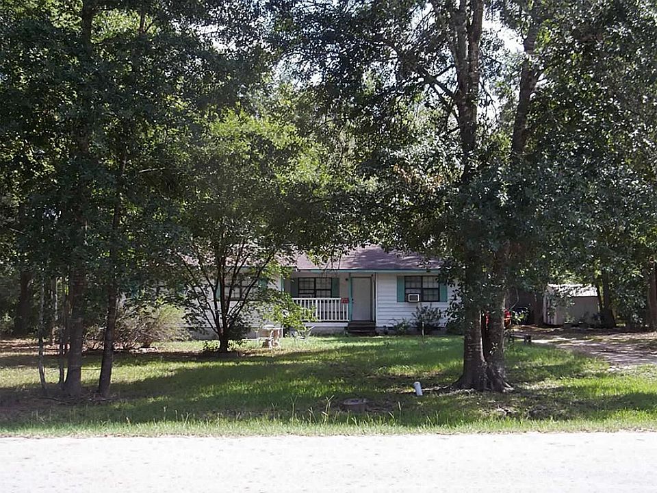 Front of house with driveway leading to house. Huge front and back yard.
