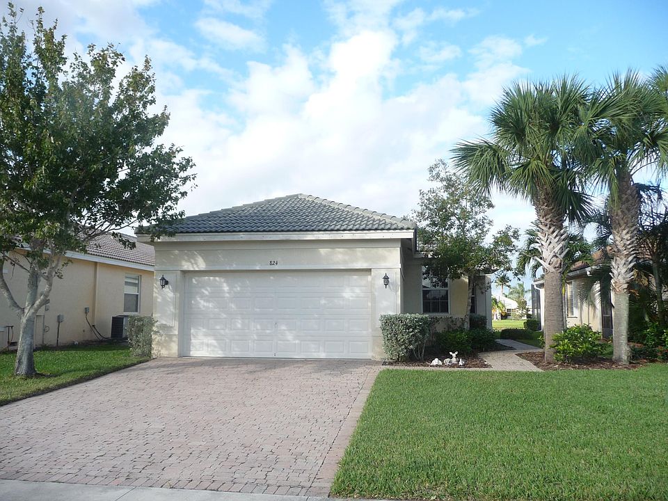 Front of house, but it's JUST been Fully Repainted. Note side Entrance. Pavers on driveway and Sidewalk to Front Door. (Animals not included!) Neighbor to the Right is almost never there. A young couple, very friendly, is to the left.