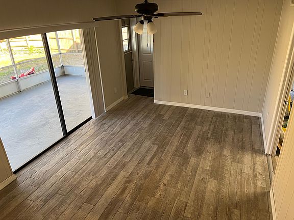 Family Room leads out to a large screened patio or 2-car garage. Durable, 'barn wood' tile floors are easy to maintain!