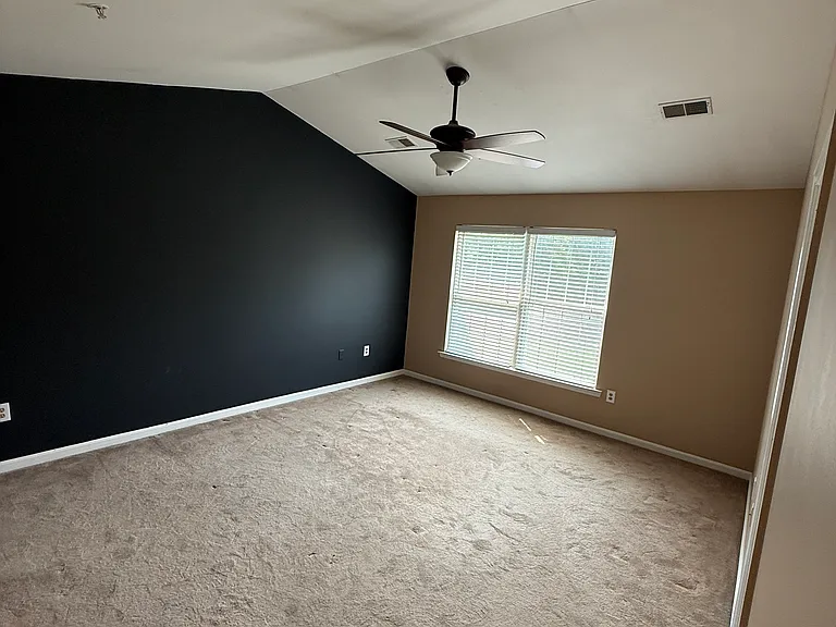 Upstairs primary bedroom with walk in closet bathroom shower and tub