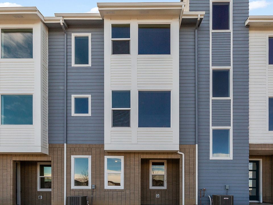 Elegant townhomes feature chic gray and white siding, expansive windows at Antora, Dillon Pointe.