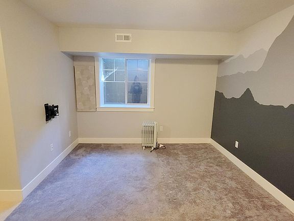 Large bedroom with window and space heater for additional heat
