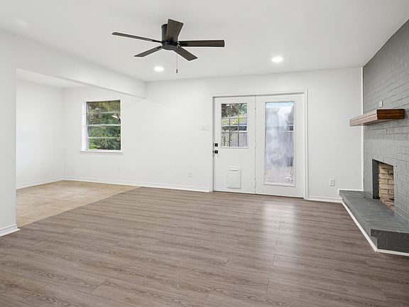 Living room with fireplace open to dining area