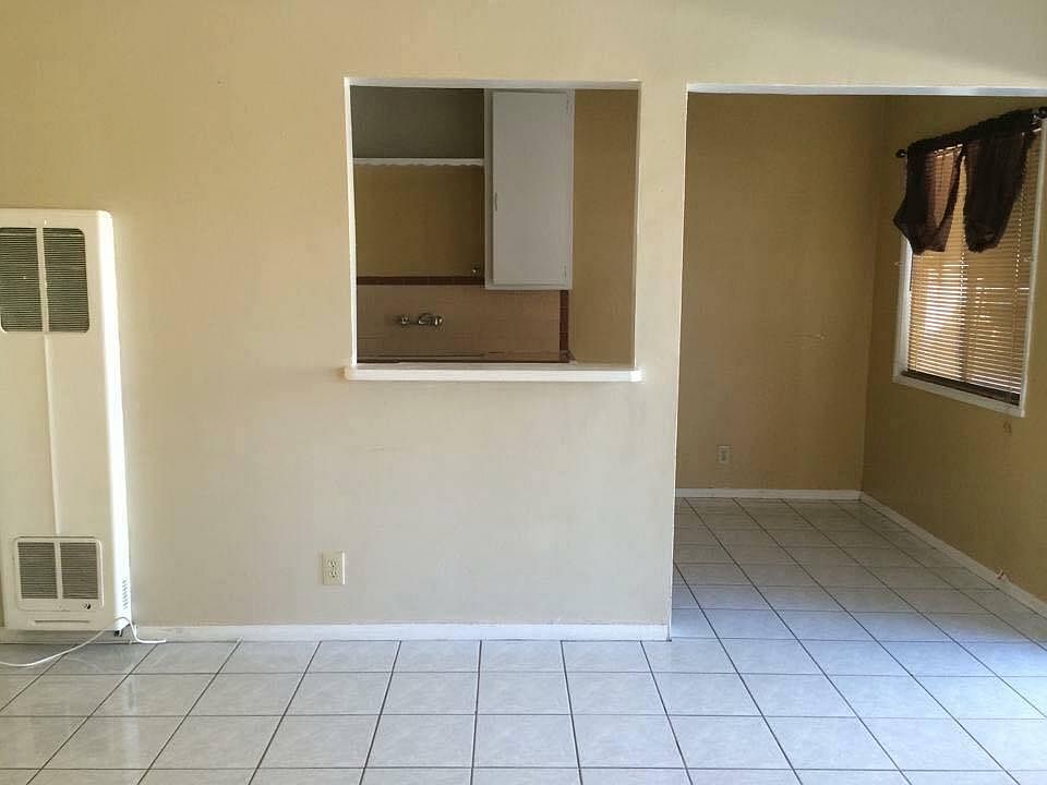 Living room looking into kitchen. Pony wall between rooms