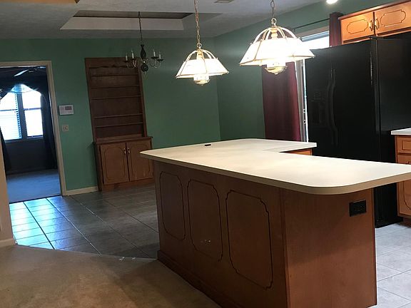 Kitchen island, dining room area. Master bedroom entrance/door.
