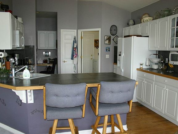 Kitchen w/Tile Countertops and Hardwood Floors