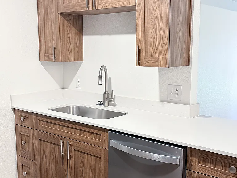 Freshly renovated kitchens featuring sleek countertops, upgraded fixtures, and abundant cabinet storage.
