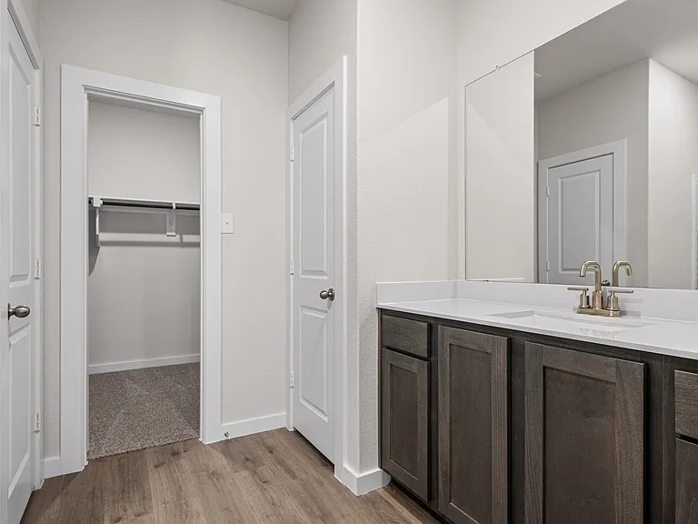 The master bathroom has a sprawling vanity.