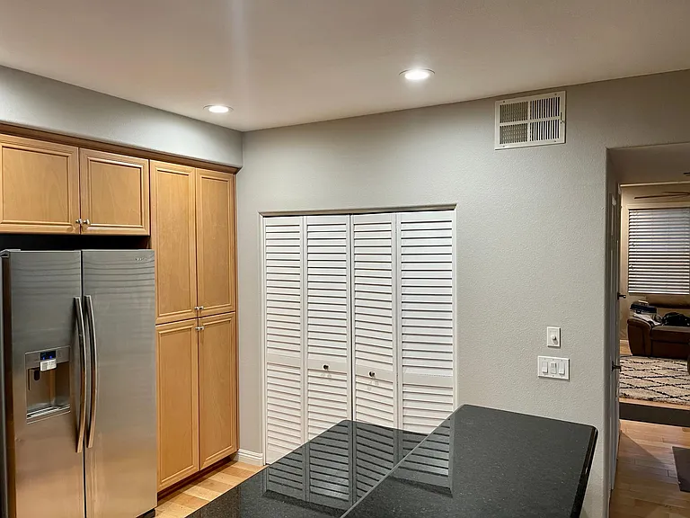 laundry in kitchen behind white doors