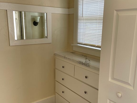 Walk-in closet with built in dresser.