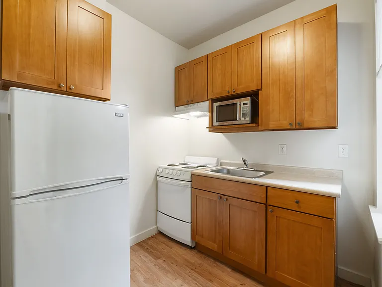 Studio kitchen with refrigerator, microwave, oven & range