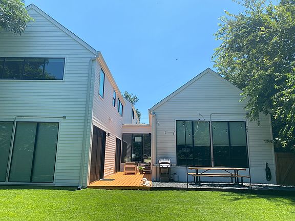Large backyard with composite decking and two 8 ft sliding glass doors to living space