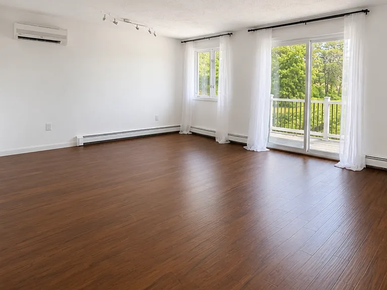Open-concept dining and living area with attached private deck